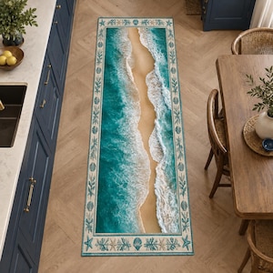 May include: A rectangular runner rug featuring a high-angle view of a sandy beach with turquoise ocean waves crashing along the shore. The rug is framed by a decorative border containing illustrations of starfish, seashells, and coral.
