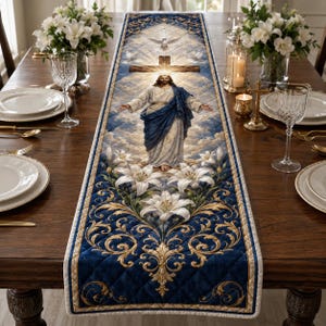 May include: A rectangular quilted table runner featuring a central image of Jesus with arms outstretched, a wooden cross, and a dove against a cloudy sky. The design includes white lilies and gold scrollwork on a deep blue background.