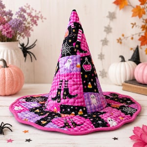 May include: A quilted witch hat featuring a patchwork design of pink gingham, black fabric with white spiderwebs, ghosts, potion bottles, candy corn, and black boots with striped stockings. The hat has a tall conical crown and a wide, scalloped brim.