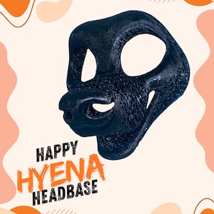 May include: A black 3D printed hyena headbase featuring a textured surface, large eye openings, and a snout. The text "HAPPY HYENA HEADBASE" is printed in black and orange lettering on the lower left side of the image, set against a light background.