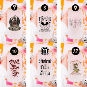 May include: Six frosted glass tumblers with bamboo lids, each featuring unique black or red graphic designs. Designs include a dragon crest, fantasy text, floral arches, and bold typography with phrases like Witch Killer and Violence Apothecary.