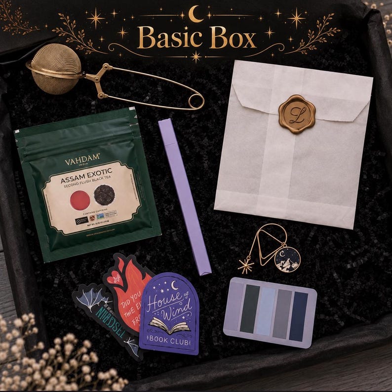 May include: A gift box set containing a gold-tone mesh tea infuser, a green Vahdam Assam Exotic black tea pouch, a lavender pen, a white envelope with a gold wax seal, a gold star and moon charm, three stickers, and a rectangular colour palette card.