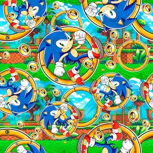May include: A repeating pattern featuring the blue character Sonic the Hedgehog in various dynamic poses, jumping through large golden rings. The background displays a vibrant green landscape with palm trees, checkered ground, and blue sky.