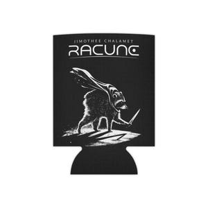 May include: A black foam can cooler featuring a white graphic illustration of a raccoon wearing a cape and holding a small knife. Above the raccoon, the text reads JIMOTHEE CHALAMET RACUNC in a stylized white font against the black background.