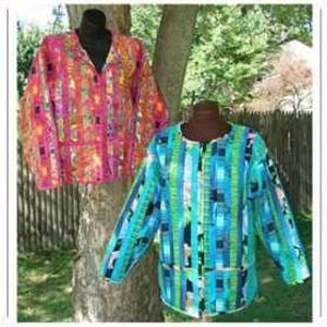 May include: Two long-sleeved jackets displayed on mannequins. One jacket features a vibrant patchwork pattern of pink, orange, and yellow vertical stripes. The second jacket displays a cool-toned patchwork design with blue, teal, and green vertical stripes.