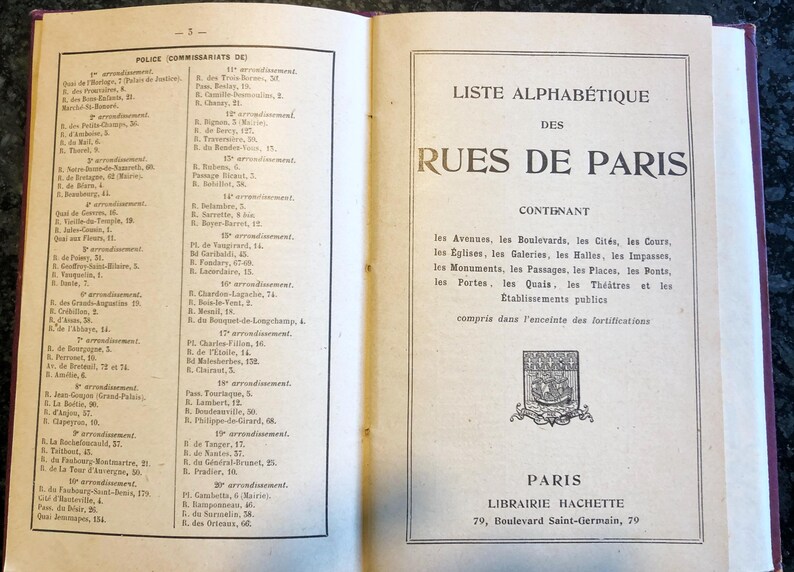May include: A black and white image of a book with a list of streets in Paris, France. The book is titled "Liste Alphabetique des Rues de Paris" and includes a list of streets, avenues, and other locations in Paris. The book is published by Librairie Hachette.