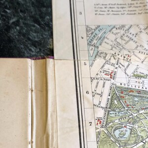 May include: A vintage map of Paris, France, showing the Seine River, the Bois de Boulogne park, and the Avenue de Madrid. The map is divided into sections numbered 3 through 7.