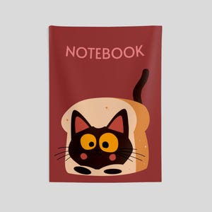 May include: A rectangular notebook with a dark red cover featuring the word NOTEBOOK in light pink letters. The center displays a graphic of a black cat with large yellow eyes and pink cheeks peeking out from a slice of toasted bread.