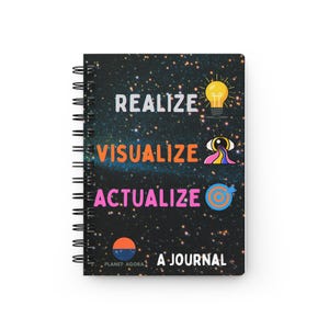 May include: A spiral-bound journal with a black cover featuring a starry space pattern. The text reads REALIZE with a lightbulb icon, VISUALIZE with an eye icon, and ACTUALIZE with a target icon. The bottom includes a logo and A JOURNAL text.