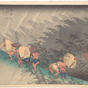 May include: A Japanese woodblock print depicting travelers walking along a path during a rainstorm. The figures wear straw capes and hats, with one person holding a paper umbrella. The scene features muted tones of green, brown, and grey.