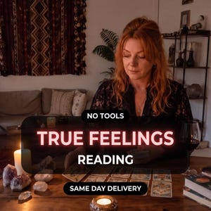May include: A person with reddish-brown hair performing a tarot card reading on a wooden table. The image features text that reads NO TOOLS TRUE FEELINGS READING SAME DAY DELIVERY. Several tarot cards are laid out alongside crystals and a candle.