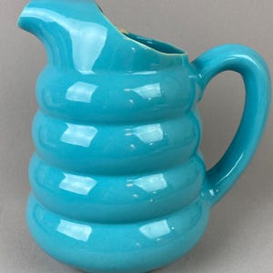 May include: A set of three ceramic mugs with a speckled, matte finish. The mugs are in shades of cream, light gray, and dark gray. Each mug has a simple, minimalist design, perfect for coffee or tea.