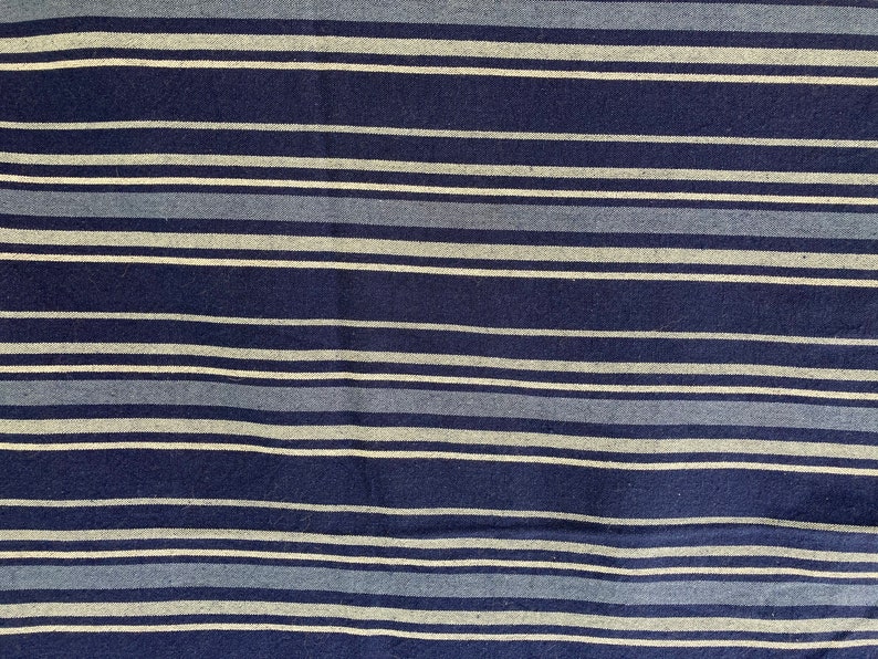 May include: Blue and white striped fabric with a woven texture.