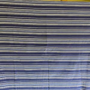 May include: A blue and white striped fabric with a subtle sheen. The fabric is woven with thin white stripes and thicker blue stripes.
