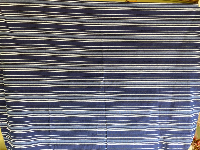 May include: A blue and white striped fabric with a subtle sheen. The fabric is woven with thin white stripes and thicker blue stripes.
