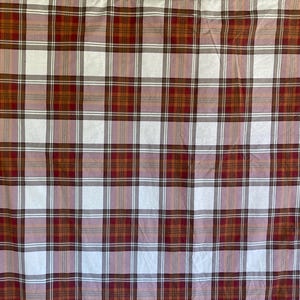 May include: A plaid fabric with a repeating pattern of red, brown, white, and light pink squares and rectangles. The fabric is likely used for bedding, curtains, or other home decor items.