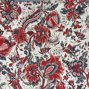 May include: Red and black floral fabric with a white background. The fabric features a repeating pattern of stylized flowers and leaves.