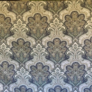 May include: Close-up of a repeating pattern featuring a floral paisley design. The pattern includes dark blue, olive green, and off-white colors. The design is symmetrical and ornate, suitable for wallpaper or fabric.