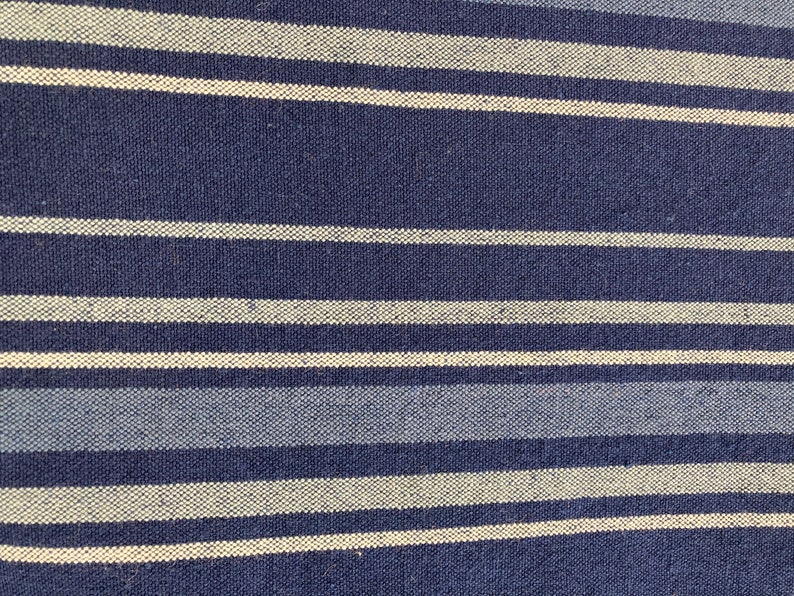 May include: Blue and white striped fabric with a woven texture.