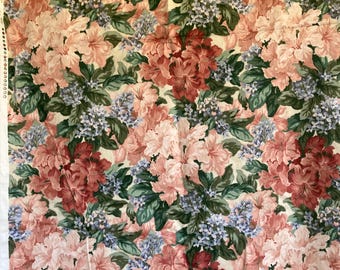 May include: Floral fabric featuring a repeating pattern of large, stylized flowers in shades of pink, peach, and burgundy. The flowers are interspersed with clusters of small, blue-purple blossoms and green leaves, all set against a cream background.