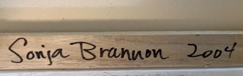 May include: Wooden frame with the artist's signature "Sonja Brannon" and the year "2004" in black ink. The frame is set against a canvas background.
