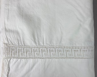 May include: White cotton sheet with a crocheted lace trim.