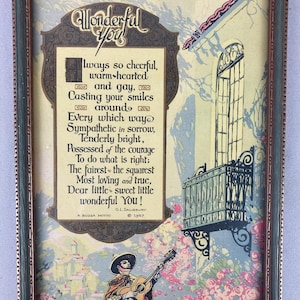 May include: Vintage framed print with a poem titled "Wonderful You." The artwork features a man playing a guitar, a balcony, and floral elements. The frame is a combination of green and brown tones, adding to its antique aesthetic.