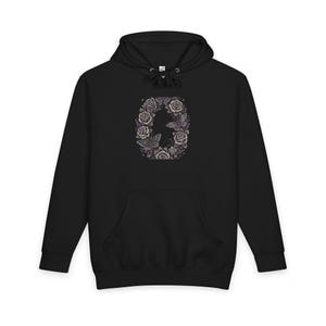 May include: A black hooded sweatshirt featuring a central graphic design of the letter O, intricately formed by a collection of detailed purple and white roses and moths. The hoodie includes a drawstring hood and a front kangaroo pocket.