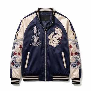 May include: A navy blue and cream satin bomber jacket featuring a front zip, striped ribbed collar, cuffs, and hem. The chest displays an embroidered white fox and Japanese kanji characters. The sleeves feature embroidered waves and moons.