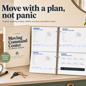 May include: A beige Moving Command Center planner binder with an open interior displaying printed organisational pages for timelines, box inventory, and utility transfers. Includes a roll of tape, a pen, and two keys on a ring on the surface.