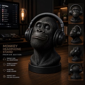 May include: A black monkey bust headphone stand featuring a detailed primate head with closed eyes and a subtle smile. The sculpture is mounted on a circular base and is shown wearing black over-ear headphones. Text on the image reads MONKEY HEADPHONE STAND PREMIUM EDITION.