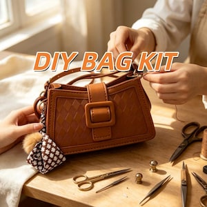 May include: A brown rectangular shoulder bag with a diamond-patterned texture, a central buckle closure, and a small dangling charm featuring a brown pom-pom and a patterned fabric piece. The text DIY BAG KIT is displayed above the bag.