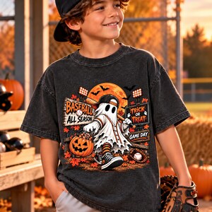 Könnte beinhalten: Ein anthrazitfarbenes Kurzarm-T-Shirt mit einer Grafik eines Geistes, der eine Baseballkappe trägt und einen Schläger sowie einen Kürbiseimer hält. Der Aufdruck enthält den Text BASEBALL ALL SEASON, TRICK OR TREAT und GAME DAY.