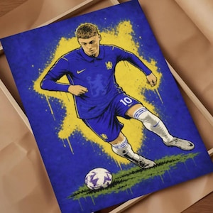 May include: A rectangular art print featuring a stylized illustration of a soccer player in a blue Chelsea kit with the number 10, dribbling a soccer ball. The background consists of a vibrant yellow and blue paint splatter effect on a dark blue field.