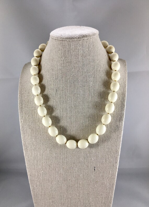 Gold necklace with white beads best sale