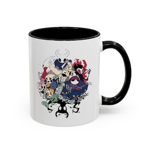 May include: A white ceramic mug with a black interior and a black handle. The exterior features a detailed, colorful graphic illustration of various animated insect-like characters from the video game Hollow Knight, arranged in a cluster.