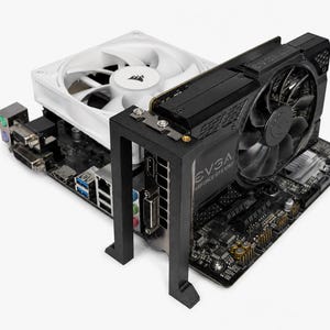 May include: A black motherboard featuring a white Corsair cooling fan and an EVGA GeForce GTX 1060 graphics card. The graphics card is supported by a black vertical mounting bracket, and the motherboard includes various input and output ports.