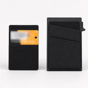May include: Two black rectangular card holders. The smaller holder on the left contains a yellow card with blurred text. The larger holder on the right features an angled exterior pocket and a small mechanical lever on the side for card access.