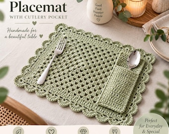 May include: A sage green rectangular crochet placemat featuring a scalloped border and an integrated side pocket for cutlery. The placemat has a central square grid pattern and is displayed with a silver fork and a silver spoon placed inside the pocket.