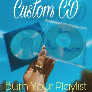 May include: A custom CD in a clear plastic jewel case and a blue paper sleeve. The disc features the handwritten blue ink text 'Burn Your Playlist'. The image includes the white text 'Custom CD' at the top and 'Burn Your Playlist' at the bottom.