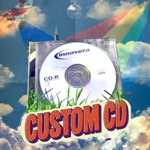 May include: A clear plastic CD-R jewel case containing an Innovera brand CD-R disc. The disc is white with blue text and a logo. Below the case, the words CUSTOM CD are printed in large, bold, orange-red letters with a dark purple outline.