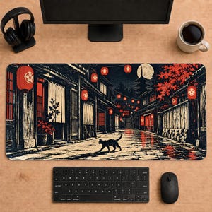 May include: A rectangular desk mat featuring a black and white illustration of a narrow street at night with a black cat walking in the center. The scene includes red paper lanterns, wooden buildings, a full moon, and a pagoda silhouette.