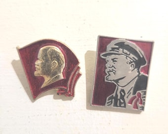 Two Vintage Soviet-era Enamel Pins Featuring Portraits of Vladimir Lenin.