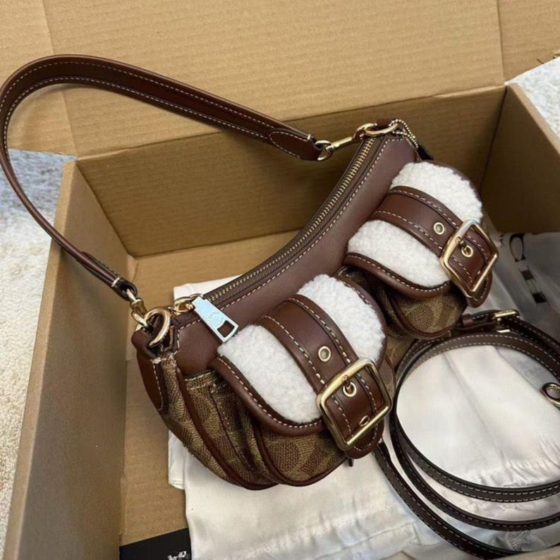 These are the Coach Ashton Shoulder Bags in signature jacquard and smooth leather, featuring distinctive front buckle pockets and detachable straps.
