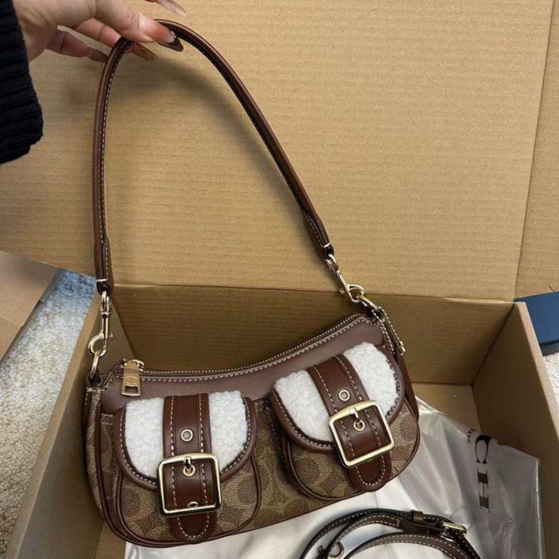 These are the Coach Ashton Shoulder Bags in signature jacquard and smooth leather, featuring distinctive front buckle pockets and detachable straps.