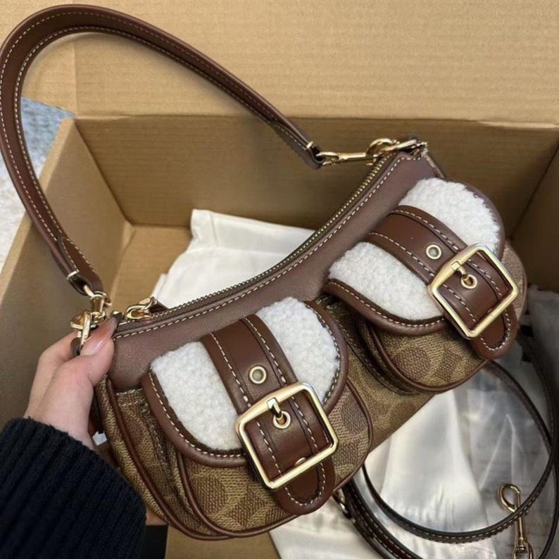 These are the Coach Ashton Shoulder Bags in signature jacquard and smooth leather, featuring distinctive front buckle pockets and detachable straps.