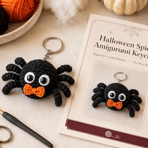 May include: A black crocheted spider keychain with large white eyes and an orange bow tie, accompanied by a printed pattern card titled Halloween Spider Amigurumi Keychain, a black crochet hook, and vintage-style metal scissors.