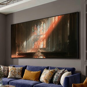 May include: A large rectangular wall art print depicting the interior of a gothic cathedral with tall stained glass windows. A bright, diagonal beam of warm orange light cuts through the dark, shadowed nave, illuminating the stone architecture.