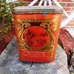 May include: Vintage red and gold tin can with an image of a tropical scene and the text "Ocean Blend Tea Co. Ltd. 247 Front St. Toronto, Ont."