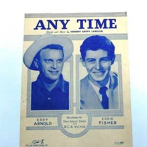 May include: A vintage sheet music cover for the song "Any Time" by Eddy Arnold and Eddie Fisher. The cover features photos of the two singers in blue and white, with the song title in bold blue letters.